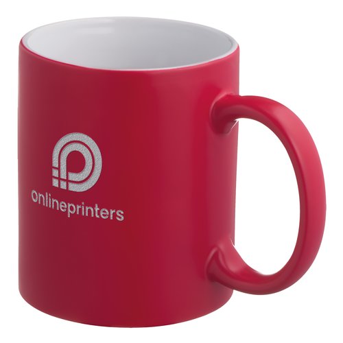 Taza roja de cermica con asa.